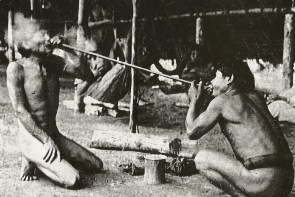 Rapeh blowing one person to another historical photo black & white